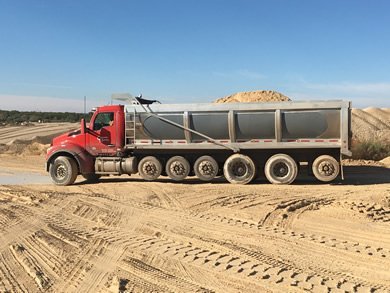 Wink half round dump trailer in operation